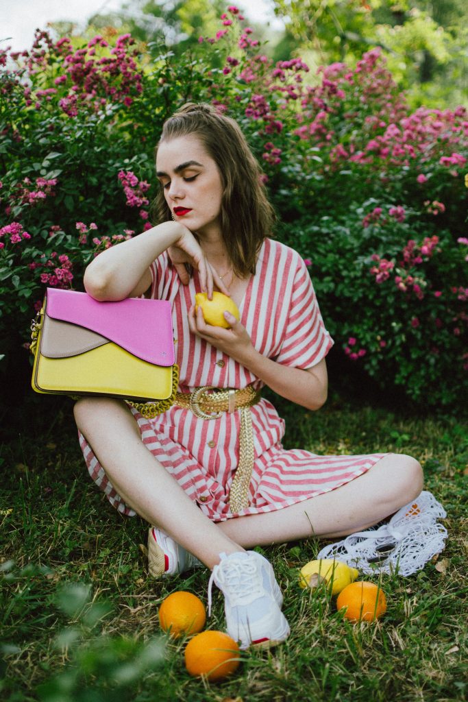 Striped midi dress, chunky white sneakers, statement colorblock shoulder bag, rose garden, coin necklace, andreea birsan, couturezilla, cute summer outfit ideas 2018, coin necklace, mango midi striped linen dress, linen dress, striped midi dress and sneakers, chunky trainers, chunky sneakers, dad sneakers trend, the ugly sneakers trend, white trainers, trainers and feminine dress, retro dress and chunky trainers, gold plated coin necklace, onecklace jewelry, isla fontaine statement shoulder bag, pink and yellow bag, the best bags from isla fontaine, mini bun hairstyle, gold metallic belt, rose garden, the necklace you need to wear this summer, red and white midi dress, crisp white sneakers, balenciaga inspired triple s sneakers, balenciaga dupe sneakers, where to find the budget alternative to the balenciaga triple s sneakers, balenciaga sneakers, trending, summer trends of 2018, how to look Parisian chic, European summer street style inspiration for women 2017, pinterest chic outfit ideas for woman, summer outfit ideas, summer ootd inspiration, outfit of the day, ootd, fashion icon, style inspiration, fashionista, fashion inspiration, style inspo, what to wear in summer, how to look French, chic on a budget, zara outfit, mango, topshop, asos, river island, forever 21, urban outfitters, how to mix high end pieces with luxury ones, zara and Gucci,outfit alternatives for summer, tomboy chic, minimal outfit, tumblr girls photos, pictures, happy girl, women, smart casual outfits, the best outfit ideas 2017, what to wear when you don’t feel inspired, summer in Europe, weekend attire, uniform, French women in summer, European outfit ideas 2017, minimal chic outfit, how to stand out, the best outfit ideas for summer, the sunglasses you have seen everywhere on Instagram, glasses, uk fashion blogger, united kingdom, uk fashion blog, fashion and travel blog, Europe, women with style, street style, summer fashion trends 2017, best fashion ideas, styling, fall fashion, fall outfit, fall ootd, fall perfect, transitional dressing, best transitional outfit ideas, how to wear statement earrings, dressing for autumn, autumn outfit, winter outfit ideas for work and school 2017