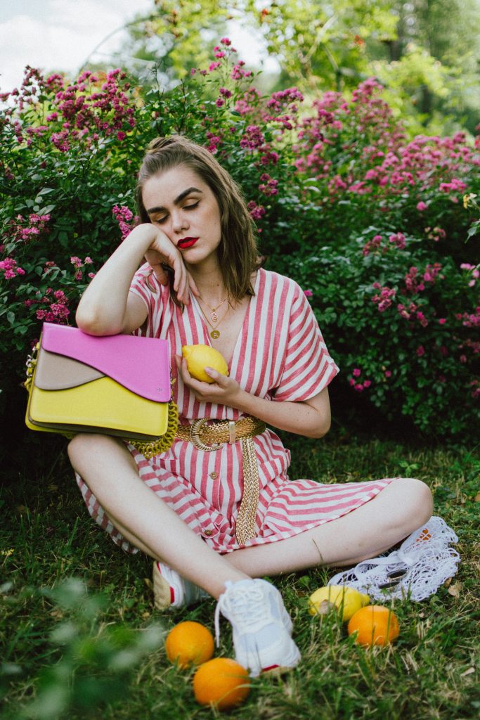 Striped midi dress, chunky white sneakers, statement colorblock shoulder bag, rose garden, coin necklace, andreea birsan, couturezilla, cute summer outfit ideas 2018, coin necklace, mango midi striped linen dress, linen dress, striped midi dress and sneakers, chunky trainers, chunky sneakers, dad sneakers trend, the ugly sneakers trend, white trainers, trainers and feminine dress, retro dress and chunky trainers, gold plated coin necklace, onecklace jewelry, isla fontaine statement shoulder bag, pink and yellow bag, the best bags from isla fontaine, mini bun hairstyle, gold metallic belt, rose garden, the necklace you need to wear this summer, red and white midi dress, crisp white sneakers, balenciaga inspired triple s sneakers, balenciaga dupe sneakers, where to find the budget alternative to the balenciaga triple s sneakers, balenciaga sneakers, trending, summer trends of 2018, how to look Parisian chic, European summer street style inspiration for women 2017, pinterest chic outfit ideas for woman, summer outfit ideas, summer ootd inspiration, outfit of the day, ootd, fashion icon, style inspiration, fashionista, fashion inspiration, style inspo, what to wear in summer, how to look French, chic on a budget, zara outfit, mango, topshop, asos, river island, forever 21, urban outfitters, how to mix high end pieces with luxury ones, zara and Gucci,outfit alternatives for summer, tomboy chic, minimal outfit, tumblr girls photos, pictures, happy girl, women, smart casual outfits, the best outfit ideas 2017, what to wear when you don’t feel inspired, summer in Europe, weekend attire, uniform, French women in summer, European outfit ideas 2017, minimal chic outfit, how to stand out, the best outfit ideas for summer, the sunglasses you have seen everywhere on Instagram, glasses, uk fashion blogger, united kingdom, uk fashion blog, fashion and travel blog, Europe, women with style, street style, summer fashion trends 2017, best fashion ideas, styling, fall fashion, fall outfit, fall ootd, fall perfect, transitional dressing, best transitional outfit ideas, how to wear statement earrings, dressing for autumn, autumn outfit, winter outfit ideas for work and school 2017