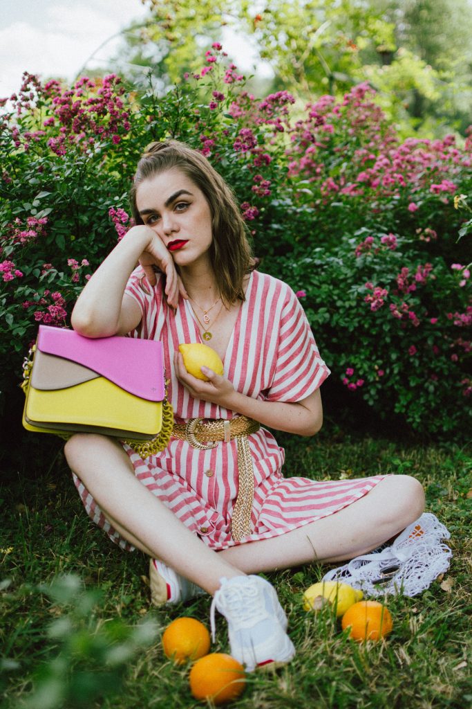 Striped midi dress, chunky white sneakers, statement colorblock shoulder bag, rose garden, coin necklace, andreea birsan, couturezilla, cute summer outfit ideas 2018, coin necklace, mango midi striped linen dress, linen dress, striped midi dress and sneakers, chunky trainers, chunky sneakers, dad sneakers trend, the ugly sneakers trend, white trainers, trainers and feminine dress, retro dress and chunky trainers, gold plated coin necklace, onecklace jewelry, isla fontaine statement shoulder bag, pink and yellow bag, the best bags from isla fontaine, mini bun hairstyle, gold metallic belt, rose garden, the necklace you need to wear this summer, red and white midi dress, crisp white sneakers, balenciaga inspired triple s sneakers, balenciaga dupe sneakers, where to find the budget alternative to the balenciaga triple s sneakers, balenciaga sneakers, trending, summer trends of 2018, how to look Parisian chic, European summer street style inspiration for women 2017, pinterest chic outfit ideas for woman, summer outfit ideas, summer ootd inspiration, outfit of the day, ootd, fashion icon, style inspiration, fashionista, fashion inspiration, style inspo, what to wear in summer, how to look French, chic on a budget, zara outfit, mango, topshop, asos, river island, forever 21, urban outfitters, how to mix high end pieces with luxury ones, zara and Gucci,outfit alternatives for summer, tomboy chic, minimal outfit, tumblr girls photos, pictures, happy girl, women, smart casual outfits, the best outfit ideas 2017, what to wear when you don’t feel inspired, summer in Europe, weekend attire, uniform, French women in summer, European outfit ideas 2017, minimal chic outfit, how to stand out, the best outfit ideas for summer, the sunglasses you have seen everywhere on Instagram, glasses, uk fashion blogger, united kingdom, uk fashion blog, fashion and travel blog, Europe, women with style, street style, summer fashion trends 2017, best fashion ideas, styling, fall fashion, fall outfit, fall ootd, fall perfect, transitional dressing, best transitional outfit ideas, how to wear statement earrings, dressing for autumn, autumn outfit, winter outfit ideas for work and school 2017
