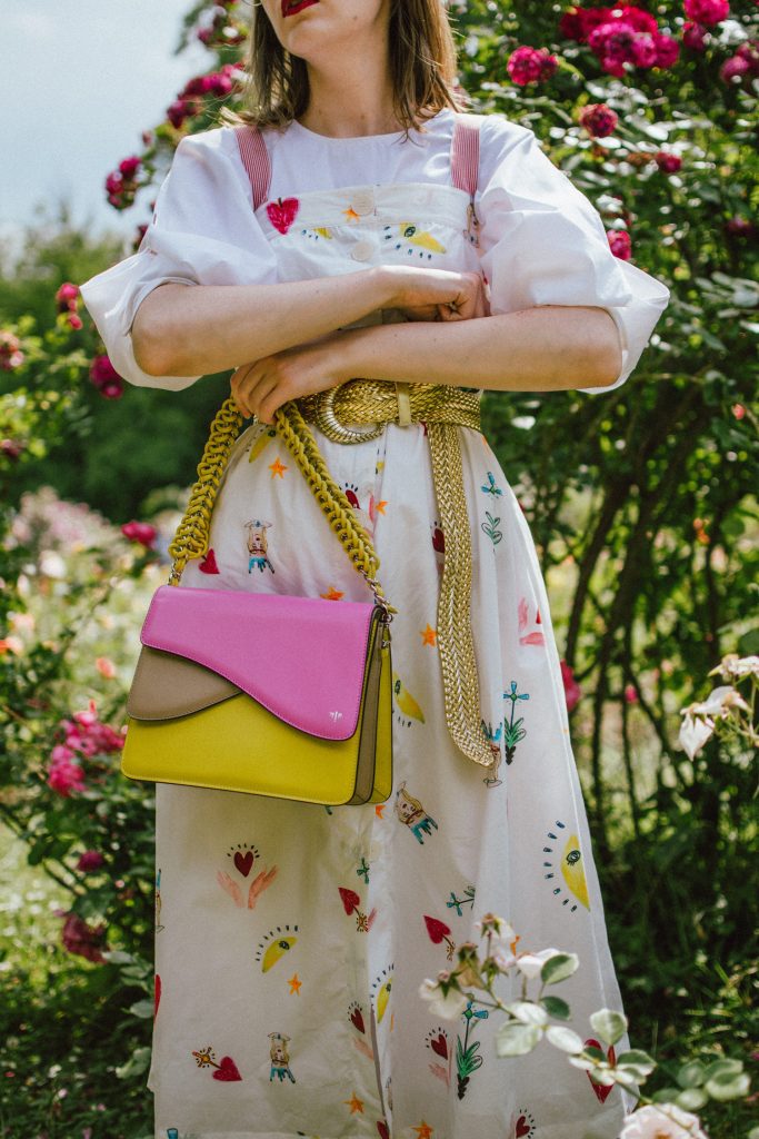 White puffy sleeves shirt, layered button front midi dress, gold metallic vintage belt, colorblock leather shoulder bag, pink mules, rose gorden editorial, andreea birsan, couturezilla, cute summer outfit ideas for 2018, step up your midi dress, how to wear a midi dress, printed dress, cotton dress, ottod’ame dress, rose gardens in bucharest, trandafiri bucuresti, gradina botanica, botanical garden, fun dress, cotton and linen, white shirt with puffy sleeves, the perfect midi dress for summer, marcie wconcept pink suede mules, korean shoes, korean mules, korean designer shoes, italian dress, beautiful bag, statement bag, yellow and pink shoulder bag, statement bag strap, isla fontaine bags, italian leather bags, how to layer a midi dress when it’s melting outside, the midi dress you should wear this summer, how to wear a puffy sleeve top, white shirt, wardrobe must have, staples, how to look Parisian chic, European summer street style inspiration for women 2017, pinterest chic outfit ideas for woman, summer outfit ideas, summer ootd inspiration, outfit of the day, ootd, fashion icon, style inspiration, fashionista, fashion inspiration, style inspo, what to wear in summer, how to look French, chic on a budget, zara outfit, mango, topshop, asos, river island, forever 21, urban outfitters, how to mix high end pieces with luxury ones, zara and Gucci,outfit alternatives for summer, tomboy chic, minimal outfit, tumblr girls photos, pictures, happy girl, women, smart casual outfits, the best outfit ideas 2017, what to wear when you don’t feel inspired, summer in Europe, weekend attire, uniform, French women in summer, European outfit ideas 2017, minimal chic outfit, how to stand out, the best outfit ideas for summer, the sunglasses you have seen everywhere on Instagram, glasses, uk fashion blogger, united kingdom, uk fashion blog, fashion and travel blog, Europe, women with style, street style, summer fashion trends 2017, best fashion ideas, styling, fall fashion, fall outfit, fall ootd, fall perfect, transitional dressing, best transitional outfit ideas, how to wear statement earrings, dressing for autumn, autumn outfit, winter outfit ideas for work and school 2017, clear lens aviator glasses, geeky glasses, clear lens glasses trend