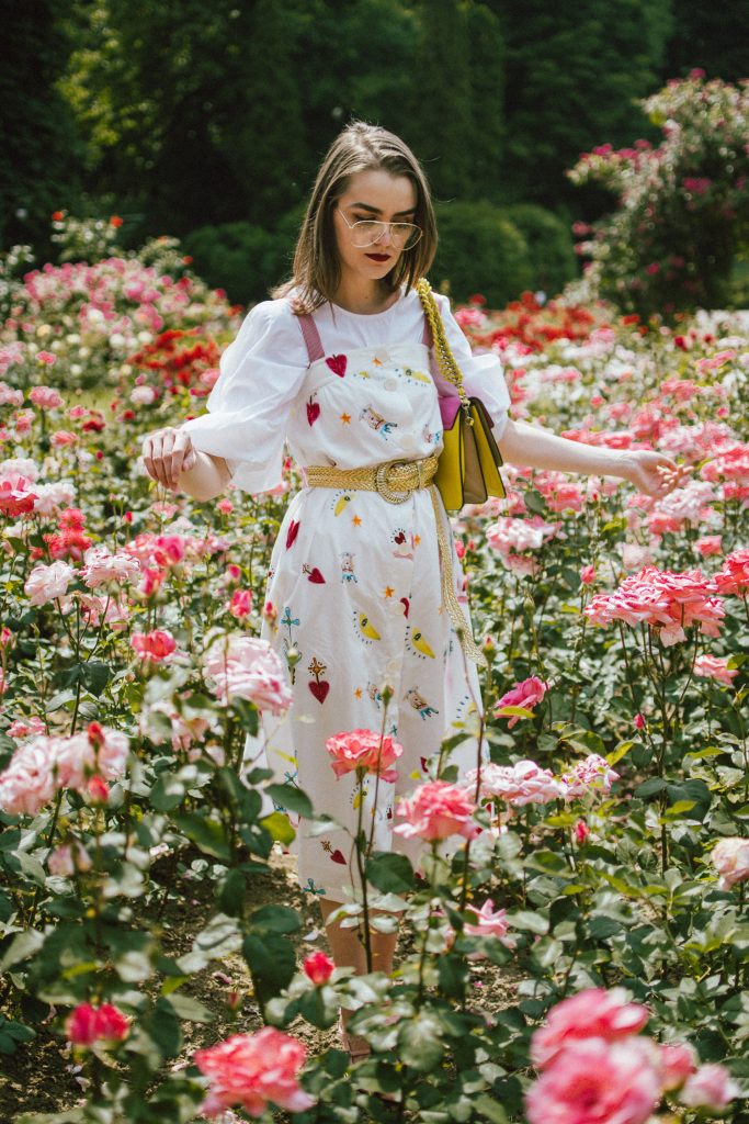 White puffy sleeves shirt, layered button front midi dress, gold metallic vintage belt, colorblock leather shoulder bag, pink mules, rose gorden editorial, andreea birsan, couturezilla, cute summer outfit ideas for 2018, step up your midi dress, how to wear a midi dress, printed dress, cotton dress, ottod’ame dress, rose gardens in bucharest, trandafiri bucuresti, gradina botanica, botanical garden, fun dress, cotton and linen, white shirt with puffy sleeves, the perfect midi dress for summer, marcie wconcept pink suede mules, korean shoes, korean mules, korean designer shoes, italian dress, beautiful bag, statement bag, yellow and pink shoulder bag, statement bag strap, isla fontaine bags, italian leather bags, how to layer a midi dress when it’s melting outside, the midi dress you should wear this summer, how to wear a puffy sleeve top, white shirt, wardrobe must have, staples, how to look Parisian chic, European summer street style inspiration for women 2017, pinterest chic outfit ideas for woman, summer outfit ideas, summer ootd inspiration, outfit of the day, ootd, fashion icon, style inspiration, fashionista, fashion inspiration, style inspo, what to wear in summer, how to look French, chic on a budget, zara outfit, mango, topshop, asos, river island, forever 21, urban outfitters, how to mix high end pieces with luxury ones, zara and Gucci,outfit alternatives for summer, tomboy chic, minimal outfit, tumblr girls photos, pictures, happy girl, women, smart casual outfits, the best outfit ideas 2017, what to wear when you don’t feel inspired, summer in Europe, weekend attire, uniform, French women in summer, European outfit ideas 2017, minimal chic outfit, how to stand out, the best outfit ideas for summer, the sunglasses you have seen everywhere on Instagram, glasses, uk fashion blogger, united kingdom, uk fashion blog, fashion and travel blog, Europe, women with style, street style, summer fashion trends 2017, best fashion ideas, styling, fall fashion, fall outfit, fall ootd, fall perfect, transitional dressing, best transitional outfit ideas, how to wear statement earrings, dressing for autumn, autumn outfit, winter outfit ideas for work and school 2017, clear lens aviator glasses, geeky glasses, clear lens glasses trend