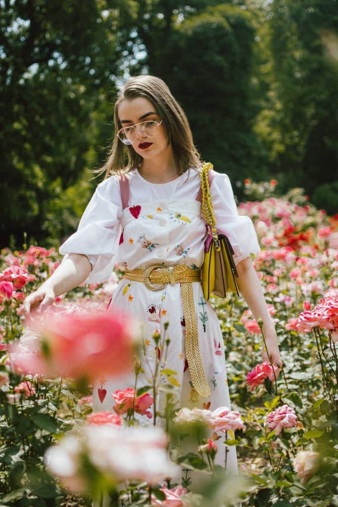 White puffy sleeves shirt, layered button front midi dress, gold metallic vintage belt, colorblock leather shoulder bag, pink mules, rose gorden editorial, andreea birsan, couturezilla, cute summer outfit ideas for 2018, step up your midi dress, how to wear a midi dress, printed dress, cotton dress, ottod’ame dress, rose gardens in bucharest, trandafiri bucuresti, gradina botanica, botanical garden, fun dress, cotton and linen, white shirt with puffy sleeves, the perfect midi dress for summer, marcie wconcept pink suede mules, korean shoes, korean mules, korean designer shoes, italian dress, beautiful bag, statement bag, yellow and pink shoulder bag, statement bag strap, isla fontaine bags, italian leather bags, how to layer a midi dress when it’s melting outside, the midi dress you should wear this summer, how to wear a puffy sleeve top, white shirt, wardrobe must have, staples, how to look Parisian chic, European summer street style inspiration for women 2017, pinterest chic outfit ideas for woman, summer outfit ideas, summer ootd inspiration, outfit of the day, ootd, fashion icon, style inspiration, fashionista, fashion inspiration, style inspo, what to wear in summer, how to look French, chic on a budget, zara outfit, mango, topshop, asos, river island, forever 21, urban outfitters, how to mix high end pieces with luxury ones, zara and Gucci,outfit alternatives for summer, tomboy chic, minimal outfit, tumblr girls photos, pictures, happy girl, women, smart casual outfits, the best outfit ideas 2017, what to wear when you don’t feel inspired, summer in Europe, weekend attire, uniform, French women in summer, European outfit ideas 2017, minimal chic outfit, how to stand out, the best outfit ideas for summer, the sunglasses you have seen everywhere on Instagram, glasses, uk fashion blogger, united kingdom, uk fashion blog, fashion and travel blog, Europe, women with style, street style, summer fashion trends 2017, best fashion ideas, styling, fall fashion, fall outfit, fall ootd, fall perfect, transitional dressing, best transitional outfit ideas, how to wear statement earrings, dressing for autumn, autumn outfit, winter outfit ideas for work and school 2017, clear lens aviator glasses, geeky glasses, clear lens glasses trend