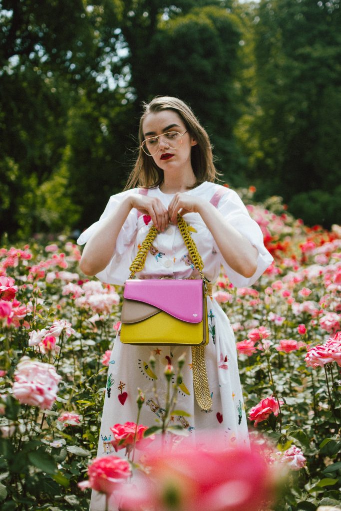 White puffy sleeves shirt, layered button front midi dress, gold metallic vintage belt, colorblock leather shoulder bag, pink mules, rose gorden editorial, andreea birsan, couturezilla, cute summer outfit ideas for 2018, step up your midi dress, how to wear a midi dress, printed dress, cotton dress, ottod’ame dress, rose gardens in bucharest, trandafiri bucuresti, gradina botanica, botanical garden, fun dress, cotton and linen, white shirt with puffy sleeves, the perfect midi dress for summer, marcie wconcept pink suede mules, korean shoes, korean mules, korean designer shoes, italian dress, beautiful bag, statement bag, yellow and pink shoulder bag, statement bag strap, isla fontaine bags, italian leather bags, how to layer a midi dress when it’s melting outside, the midi dress you should wear this summer, how to wear a puffy sleeve top, white shirt, wardrobe must have, staples, how to look Parisian chic, European summer street style inspiration for women 2017, pinterest chic outfit ideas for woman, summer outfit ideas, summer ootd inspiration, outfit of the day, ootd, fashion icon, style inspiration, fashionista, fashion inspiration, style inspo, what to wear in summer, how to look French, chic on a budget, zara outfit, mango, topshop, asos, river island, forever 21, urban outfitters, how to mix high end pieces with luxury ones, zara and Gucci,outfit alternatives for summer, tomboy chic, minimal outfit, tumblr girls photos, pictures, happy girl, women, smart casual outfits, the best outfit ideas 2017, what to wear when you don’t feel inspired, summer in Europe, weekend attire, uniform, French women in summer, European outfit ideas 2017, minimal chic outfit, how to stand out, the best outfit ideas for summer, the sunglasses you have seen everywhere on Instagram, glasses, uk fashion blogger, united kingdom, uk fashion blog, fashion and travel blog, Europe, women with style, street style, summer fashion trends 2017, best fashion ideas, styling, fall fashion, fall outfit, fall ootd, fall perfect, transitional dressing, best transitional outfit ideas, how to wear statement earrings, dressing for autumn, autumn outfit, winter outfit ideas for work and school 2017, clear lens aviator glasses, geeky glasses, clear lens glasses trend