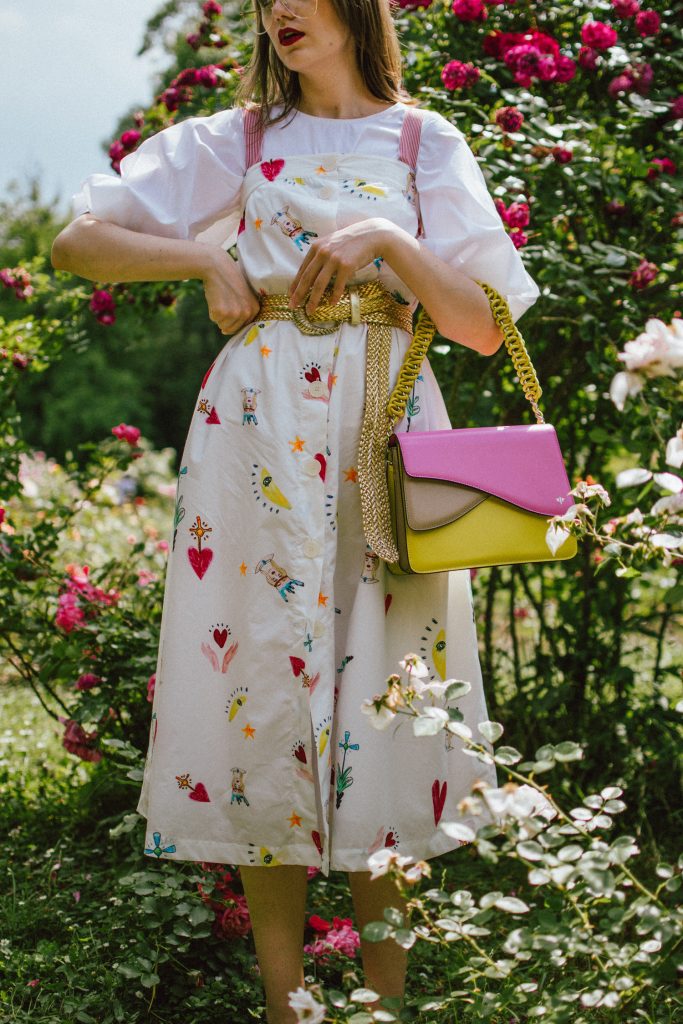 White puffy sleeves shirt, layered button front midi dress, gold metallic vintage belt, colorblock leather shoulder bag, pink mules, rose gorden editorial, andreea birsan, couturezilla, cute summer outfit ideas for 2018, step up your midi dress, how to wear a midi dress, printed dress, cotton dress, ottod’ame dress, rose gardens in bucharest, trandafiri bucuresti, gradina botanica, botanical garden, fun dress, cotton and linen, white shirt with puffy sleeves, the perfect midi dress for summer, marcie wconcept pink suede mules, korean shoes, korean mules, korean designer shoes, italian dress, beautiful bag, statement bag, yellow and pink shoulder bag, statement bag strap, isla fontaine bags, italian leather bags, how to layer a midi dress when it’s melting outside, the midi dress you should wear this summer, how to wear a puffy sleeve top, white shirt, wardrobe must have, staples, how to look Parisian chic, European summer street style inspiration for women 2017, pinterest chic outfit ideas for woman, summer outfit ideas, summer ootd inspiration, outfit of the day, ootd, fashion icon, style inspiration, fashionista, fashion inspiration, style inspo, what to wear in summer, how to look French, chic on a budget, zara outfit, mango, topshop, asos, river island, forever 21, urban outfitters, how to mix high end pieces with luxury ones, zara and Gucci,outfit alternatives for summer, tomboy chic, minimal outfit, tumblr girls photos, pictures, happy girl, women, smart casual outfits, the best outfit ideas 2017, what to wear when you don’t feel inspired, summer in Europe, weekend attire, uniform, French women in summer, European outfit ideas 2017, minimal chic outfit, how to stand out, the best outfit ideas for summer, the sunglasses you have seen everywhere on Instagram, glasses, uk fashion blogger, united kingdom, uk fashion blog, fashion and travel blog, Europe, women with style, street style, summer fashion trends 2017, best fashion ideas, styling, fall fashion, fall outfit, fall ootd, fall perfect, transitional dressing, best transitional outfit ideas, how to wear statement earrings, dressing for autumn, autumn outfit, winter outfit ideas for work and school 2017, clear lens aviator glasses, geeky glasses, clear lens glasses trend