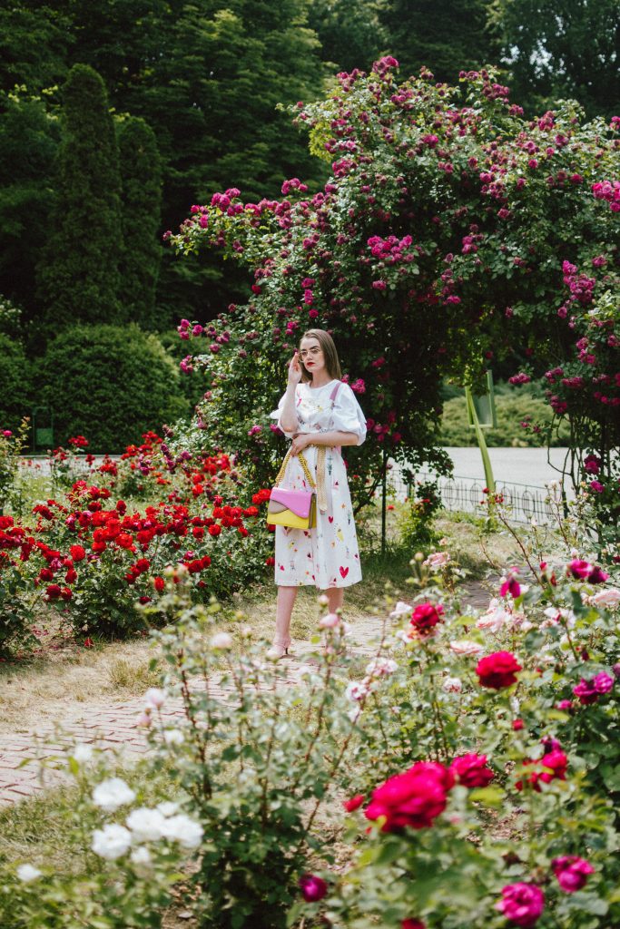 White puffy sleeves shirt, layered button front midi dress, gold metallic vintage belt, colorblock leather shoulder bag, pink mules, rose gorden editorial, andreea birsan, couturezilla, cute summer outfit ideas for 2018, step up your midi dress, how to wear a midi dress, printed dress, cotton dress, ottod’ame dress, rose gardens in bucharest, trandafiri bucuresti, gradina botanica, botanical garden, fun dress, cotton and linen, white shirt with puffy sleeves, the perfect midi dress for summer, marcie wconcept pink suede mules, korean shoes, korean mules, korean designer shoes, italian dress, beautiful bag, statement bag, yellow and pink shoulder bag, statement bag strap, isla fontaine bags, italian leather bags, how to layer a midi dress when it’s melting outside, the midi dress you should wear this summer, how to wear a puffy sleeve top, white shirt, wardrobe must have, staples, how to look Parisian chic, European summer street style inspiration for women 2017, pinterest chic outfit ideas for woman, summer outfit ideas, summer ootd inspiration, outfit of the day, ootd, fashion icon, style inspiration, fashionista, fashion inspiration, style inspo, what to wear in summer, how to look French, chic on a budget, zara outfit, mango, topshop, asos, river island, forever 21, urban outfitters, how to mix high end pieces with luxury ones, zara and Gucci,outfit alternatives for summer, tomboy chic, minimal outfit, tumblr girls photos, pictures, happy girl, women, smart casual outfits, the best outfit ideas 2017, what to wear when you don’t feel inspired, summer in Europe, weekend attire, uniform, French women in summer, European outfit ideas 2017, minimal chic outfit, how to stand out, the best outfit ideas for summer, the sunglasses you have seen everywhere on Instagram, glasses, uk fashion blogger, united kingdom, uk fashion blog, fashion and travel blog, Europe, women with style, street style, summer fashion trends 2017, best fashion ideas, styling, fall fashion, fall outfit, fall ootd, fall perfect, transitional dressing, best transitional outfit ideas, how to wear statement earrings, dressing for autumn, autumn outfit, winter outfit ideas for work and school 2017, clear lens aviator glasses, geeky glasses, clear lens glasses trend