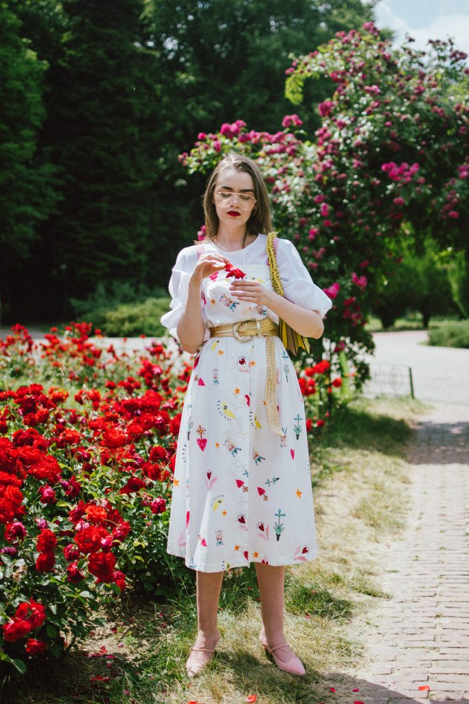 White puffy sleeves shirt, layered button front midi dress, gold metallic vintage belt, colorblock leather shoulder bag, pink mules, rose gorden editorial, andreea birsan, couturezilla, cute summer outfit ideas for 2018, step up your midi dress, how to wear a midi dress, printed dress, cotton dress, ottod’ame dress, rose gardens in bucharest, trandafiri bucuresti, gradina botanica, botanical garden, fun dress, cotton and linen, white shirt with puffy sleeves, the perfect midi dress for summer, marcie wconcept pink suede mules, korean shoes, korean mules, korean designer shoes, italian dress, beautiful bag, statement bag, yellow and pink shoulder bag, statement bag strap, isla fontaine bags, italian leather bags, how to layer a midi dress when it’s melting outside, the midi dress you should wear this summer, how to wear a puffy sleeve top, white shirt, wardrobe must have, staples, how to look Parisian chic, European summer street style inspiration for women 2017, pinterest chic outfit ideas for woman, summer outfit ideas, summer ootd inspiration, outfit of the day, ootd, fashion icon, style inspiration, fashionista, fashion inspiration, style inspo, what to wear in summer, how to look French, chic on a budget, zara outfit, mango, topshop, asos, river island, forever 21, urban outfitters, how to mix high end pieces with luxury ones, zara and Gucci,outfit alternatives for summer, tomboy chic, minimal outfit, tumblr girls photos, pictures, happy girl, women, smart casual outfits, the best outfit ideas 2017, what to wear when you don’t feel inspired, summer in Europe, weekend attire, uniform, French women in summer, European outfit ideas 2017, minimal chic outfit, how to stand out, the best outfit ideas for summer, the sunglasses you have seen everywhere on Instagram, glasses, uk fashion blogger, united kingdom, uk fashion blog, fashion and travel blog, Europe, women with style, street style, summer fashion trends 2017, best fashion ideas, styling, fall fashion, fall outfit, fall ootd, fall perfect, transitional dressing, best transitional outfit ideas, how to wear statement earrings, dressing for autumn, autumn outfit, winter outfit ideas for work and school 2017, clear lens aviator glasses, geeky glasses, clear lens glasses trend