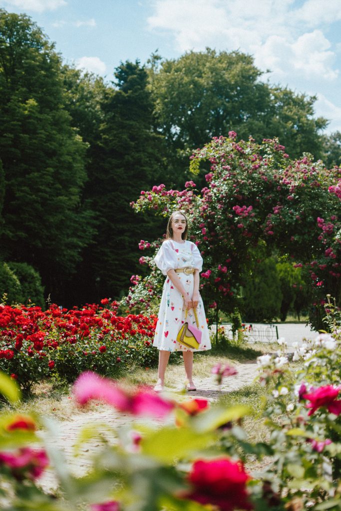 White puffy sleeves shirt, layered button front midi dress, gold metallic vintage belt, colorblock leather shoulder bag, pink mules, rose gorden editorial, andreea birsan, couturezilla, cute summer outfit ideas for 2018, step up your midi dress, how to wear a midi dress, printed dress, cotton dress, ottod’ame dress, rose gardens in bucharest, trandafiri bucuresti, gradina botanica, botanical garden, fun dress, cotton and linen, white shirt with puffy sleeves, the perfect midi dress for summer, marcie wconcept pink suede mules, korean shoes, korean mules, korean designer shoes, italian dress, beautiful bag, statement bag, yellow and pink shoulder bag, statement bag strap, isla fontaine bags, italian leather bags, how to layer a midi dress when it’s melting outside, the midi dress you should wear this summer, how to wear a puffy sleeve top, white shirt, wardrobe must have, staples, how to look Parisian chic, European summer street style inspiration for women 2017, pinterest chic outfit ideas for woman, summer outfit ideas, summer ootd inspiration, outfit of the day, ootd, fashion icon, style inspiration, fashionista, fashion inspiration, style inspo, what to wear in summer, how to look French, chic on a budget, zara outfit, mango, topshop, asos, river island, forever 21, urban outfitters, how to mix high end pieces with luxury ones, zara and Gucci,outfit alternatives for summer, tomboy chic, minimal outfit, tumblr girls photos, pictures, happy girl, women, smart casual outfits, the best outfit ideas 2017, what to wear when you don’t feel inspired, summer in Europe, weekend attire, uniform, French women in summer, European outfit ideas 2017, minimal chic outfit, how to stand out, the best outfit ideas for summer, the sunglasses you have seen everywhere on Instagram, glasses, uk fashion blogger, united kingdom, uk fashion blog, fashion and travel blog, Europe, women with style, street style, summer fashion trends 2017, best fashion ideas, styling, fall fashion, fall outfit, fall ootd, fall perfect, transitional dressing, best transitional outfit ideas, how to wear statement earrings, dressing for autumn, autumn outfit, winter outfit ideas for work and school 2017, clear lens aviator glasses, geeky glasses, clear lens glasses trend