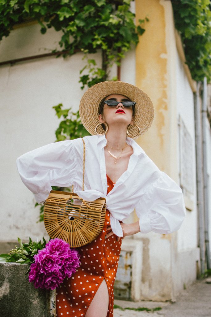 Summer bags 2018, andreea birsan summer bags edit, straw bags, wicker bags, raffia bags, pom pom, couturezilla, cult gaia ark bag, bag inspo 2018, bag trends, natural bags, hand made bags, the best summer bags of 2018, how to style beach bags in the city, the easy way to wear straw bags, the best straw bags around, asos, topshop, sea and grass, boho peach, cult gaia inspired bags, cult gaia ark bag, where to find the best summer bags of 2018, 2018 fresh casual ideas, american style, andreea birsan street styles, asos, casual off duty style, couturezilla, cute and casual outfits for spring 2018, european fashion blogger, fashion inspiration, fashion inspo, fashionista, how to dress like a parisian, how to look parisian chic, how to make minimal outfits stand out, mango, minimal outfits for spring, modern minimalism, ootd, outfit of the day, pinterest outfit for women, red cat eye sunglasses, red lipstick, romanian fashion blog, romanian fashion blogger, silk scarf, spring fashion trends for 2018, spring outfit inspiration 2018, spring outfits for women, spring street style 2018, topshop, tumblr girls outfit, women with style, zara, uk blogger, fall dressing, transitional outfits, autumn ootd, autumn outfit, fall fashion, winter outfit ideas 2018, cute winter ootd, winter outfit ideas for work and school, street style 2018, balloon sleeve white shirt, tied shirt, shirt over dress, polka dot rusty midi dress, polka dot dress with spaghetti straps, polka dot dress, gold layered necklaces, name necklace, cult gaia ark bamboo bag, peonies, big gold hoop earrings, small cat eye sunglasses, the micro sunglasses trend, straw boater hat