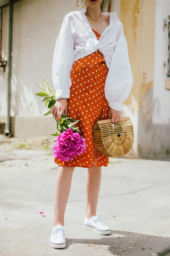 Orange boohoo midi polka dot midi dress, mango white balloon sleeve shirt shirt, h&m natural straw hat, cult gaia ark bag, tommy hilfiger white sneakers, andreea birsan, couturezilla, cute summer outfit ideas 2018. white trainers and dress, midi dress and sneakers, what to wear with a polka dot dress, midi polka dot dress with slit, orange dress, how to wear orange, what to wear with orange, rust color dress, what colors to wear this summer, how to wear sneakers and dresses, mixing feminine with masculine elements, athleisure, sexy polka dot dress, boater hat, cult gaia ark inspired bag, petite sardine bag, portuguese bag, bamboo bag, how to wear a white shirt, button up shirt, cotton shirt, how to layer in summer, layered summer dress, summer layers, white sneakers, white trainers, tommy hilfiger, gold accessories, small cat eye sunglasses, 90s inspired sunglasses, micro sunglasses trend, mini sunglasses, cat eye sunnies, the sold out asos sunglasses, chic bags to wear in spring and summer, raffia bag, straw bag, handmade bag, peonies, how to look Parisian chic, European summer street style inspiration for women 2017, pinterest chic outfit ideas for woman, summer outfit ideas, summer ootd inspiration, outfit of the day, ootd, fashion icon, style inspiration, fashionista, fashion inspiration, style inspo, what to wear in summer, how to look French, chic on a budget, zara outfit, mango, topshop, asos, river island, forever 21, urban outfitters, how to mix high end pieces with luxury ones, zara and Gucci,outfit alternatives for summer, tomboy chic, minimal outfit, tumblr girls photos, pictures, happy girl, women, smart casual outfits, the best outfit ideas 2017, what to wear when you don’t feel inspired, summer in Europe, weekend attire, uniform, French women in summer, European outfit ideas 2017, minimal chic outfit, how to stand out, the best outfit ideas for summer, the sunglasses you have seen everywhere on Instagram, glasses, uk fashion blogger, united kingdom, uk fashion blog, fashion and travel blog, Europe, women with style, street style, summer fashion trends 2017, best fashion ideas, styling, fall fashion, fall outfit, fall ootd, fall perfect, transitional dressing, best transitional outfit ideas, how to wear statement earrings, dressing for autumn, autumn outfit, winter outfit ideas for work and school 2017