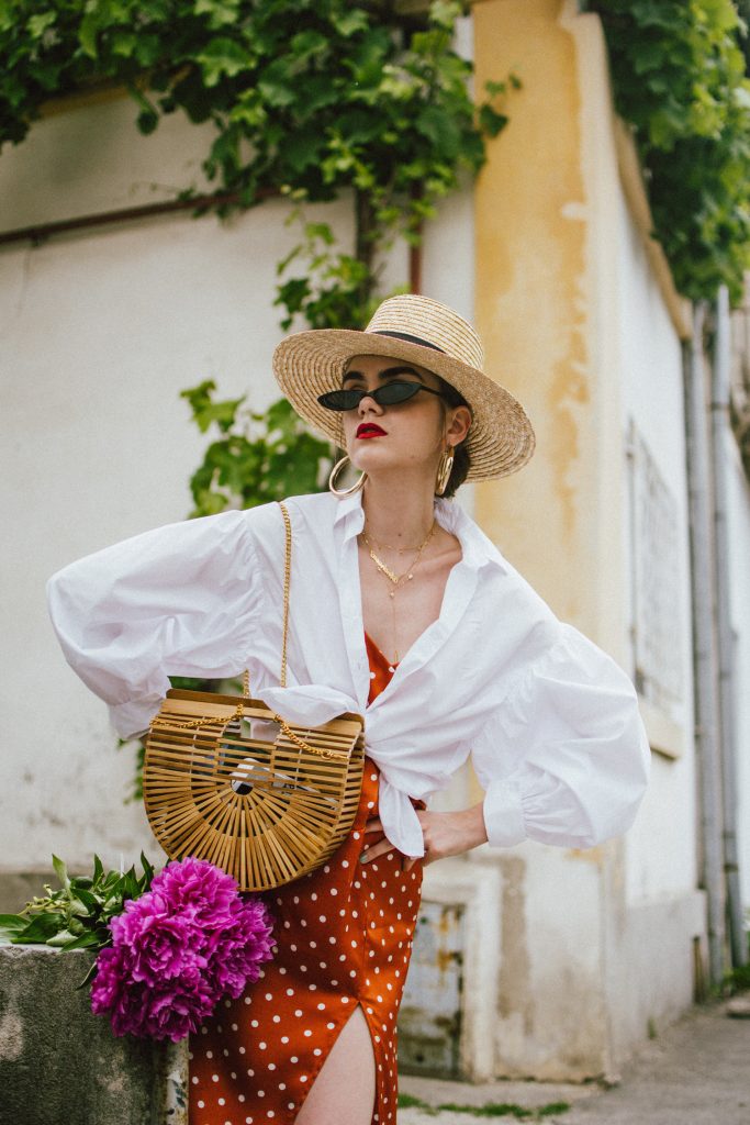 Orange boohoo midi polka dot midi dress, mango white balloon sleeve shirt shirt, h&m natural straw hat, cult gaia ark bag, tommy hilfiger white sneakers, andreea birsan, couturezilla, cute summer outfit ideas 2018. white trainers and dress, midi dress and sneakers, what to wear with a polka dot dress, midi polka dot dress with slit, orange dress, how to wear orange, what to wear with orange, rust color dress, what colors to wear this summer, how to wear sneakers and dresses, mixing feminine with masculine elements, athleisure, sexy polka dot dress, boater hat, cult gaia ark inspired bag, petite sardine bag, portuguese bag, bamboo bag, how to wear a white shirt, button up shirt, cotton shirt, how to layer in summer, layered summer dress, summer layers, white sneakers, white trainers, tommy hilfiger, gold accessories, small cat eye sunglasses, 90s inspired sunglasses, micro sunglasses trend, mini sunglasses, cat eye sunnies, the sold out asos sunglasses, chic bags to wear in spring and summer, raffia bag, straw bag, handmade bag, peonies, how to look Parisian chic, European summer street style inspiration for women 2017, pinterest chic outfit ideas for woman, summer outfit ideas, summer ootd inspiration, outfit of the day, ootd, fashion icon, style inspiration, fashionista, fashion inspiration, style inspo, what to wear in summer, how to look French, chic on a budget, zara outfit, mango, topshop, asos, river island, forever 21, urban outfitters, how to mix high end pieces with luxury ones, zara and Gucci,outfit alternatives for summer, tomboy chic, minimal outfit, tumblr girls photos, pictures, happy girl, women, smart casual outfits, the best outfit ideas 2017, what to wear when you don’t feel inspired, summer in Europe, weekend attire, uniform, French women in summer, European outfit ideas 2017, minimal chic outfit, how to stand out, the best outfit ideas for summer, the sunglasses you have seen everywhere on Instagram, glasses, uk fashion blogger, united kingdom, uk fashion blog, fashion and travel blog, Europe, women with style, street style, summer fashion trends 2017, best fashion ideas, styling, fall fashion, fall outfit, fall ootd, fall perfect, transitional dressing, best transitional outfit ideas, how to wear statement earrings, dressing for autumn, autumn outfit, winter outfit ideas for work and school 2017