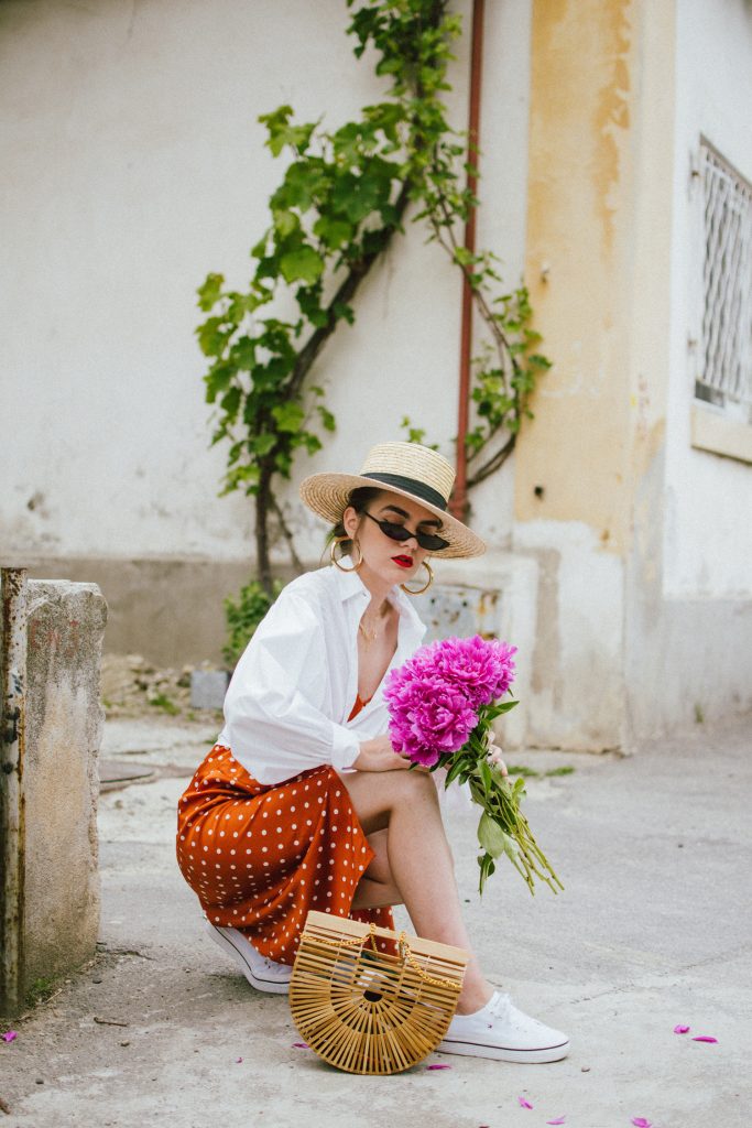 Orange boohoo midi polka dot midi dress, mango white balloon sleeve shirt shirt, h&m natural straw hat, cult gaia ark bag, tommy hilfiger white sneakers, andreea birsan, couturezilla, cute summer outfit ideas 2018. white trainers and dress, midi dress and sneakers, what to wear with a polka dot dress, midi polka dot dress with slit, orange dress, how to wear orange, what to wear with orange, rust color dress, what colors to wear this summer, how to wear sneakers and dresses, mixing feminine with masculine elements, athleisure, sexy polka dot dress, boater hat, cult gaia ark inspired bag, petite sardine bag, portuguese bag, bamboo bag, how to wear a white shirt, button up shirt, cotton shirt, how to layer in summer, layered summer dress, summer layers, white sneakers, white trainers, tommy hilfiger, gold accessories, small cat eye sunglasses, 90s inspired sunglasses, micro sunglasses trend, mini sunglasses, cat eye sunnies, the sold out asos sunglasses, chic bags to wear in spring and summer, raffia bag, straw bag, handmade bag, peonies, how to look Parisian chic, European summer street style inspiration for women 2017, pinterest chic outfit ideas for woman, summer outfit ideas, summer ootd inspiration, outfit of the day, ootd, fashion icon, style inspiration, fashionista, fashion inspiration, style inspo, what to wear in summer, how to look French, chic on a budget, zara outfit, mango, topshop, asos, river island, forever 21, urban outfitters, how to mix high end pieces with luxury ones, zara and Gucci,outfit alternatives for summer, tomboy chic, minimal outfit, tumblr girls photos, pictures, happy girl, women, smart casual outfits, the best outfit ideas 2017, what to wear when you don’t feel inspired, summer in Europe, weekend attire, uniform, French women in summer, European outfit ideas 2017, minimal chic outfit, how to stand out, the best outfit ideas for summer, the sunglasses you have seen everywhere on Instagram, glasses, uk fashion blogger, united kingdom, uk fashion blog, fashion and travel blog, Europe, women with style, street style, summer fashion trends 2017, best fashion ideas, styling, fall fashion, fall outfit, fall ootd, fall perfect, transitional dressing, best transitional outfit ideas, how to wear statement earrings, dressing for autumn, autumn outfit, winter outfit ideas for work and school 2017