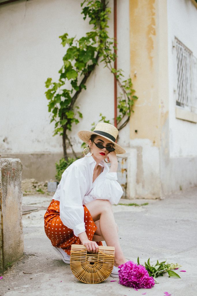 Orange boohoo midi polka dot midi dress, mango white balloon sleeve shirt shirt, h&m natural straw hat, cult gaia ark bag, tommy hilfiger white sneakers, andreea birsan, couturezilla, cute summer outfit ideas 2018. white trainers and dress, midi dress and sneakers, what to wear with a polka dot dress, midi polka dot dress with slit, orange dress, how to wear orange, what to wear with orange, rust color dress, what colors to wear this summer, how to wear sneakers and dresses, mixing feminine with masculine elements, athleisure, sexy polka dot dress, boater hat, cult gaia ark inspired bag, petite sardine bag, portuguese bag, bamboo bag, how to wear a white shirt, button up shirt, cotton shirt, how to layer in summer, layered summer dress, summer layers, white sneakers, white trainers, tommy hilfiger, gold accessories, small cat eye sunglasses, 90s inspired sunglasses, micro sunglasses trend, mini sunglasses, cat eye sunnies, the sold out asos sunglasses, chic bags to wear in spring and summer, raffia bag, straw bag, handmade bag, peonies, how to look Parisian chic, European summer street style inspiration for women 2017, pinterest chic outfit ideas for woman, summer outfit ideas, summer ootd inspiration, outfit of the day, ootd, fashion icon, style inspiration, fashionista, fashion inspiration, style inspo, what to wear in summer, how to look French, chic on a budget, zara outfit, mango, topshop, asos, river island, forever 21, urban outfitters, how to mix high end pieces with luxury ones, zara and Gucci,outfit alternatives for summer, tomboy chic, minimal outfit, tumblr girls photos, pictures, happy girl, women, smart casual outfits, the best outfit ideas 2017, what to wear when you don’t feel inspired, summer in Europe, weekend attire, uniform, French women in summer, European outfit ideas 2017, minimal chic outfit, how to stand out, the best outfit ideas for summer, the sunglasses you have seen everywhere on Instagram, glasses, uk fashion blogger, united kingdom, uk fashion blog, fashion and travel blog, Europe, women with style, street style, summer fashion trends 2017, best fashion ideas, styling, fall fashion, fall outfit, fall ootd, fall perfect, transitional dressing, best transitional outfit ideas, how to wear statement earrings, dressing for autumn, autumn outfit, winter outfit ideas for work and school 2017