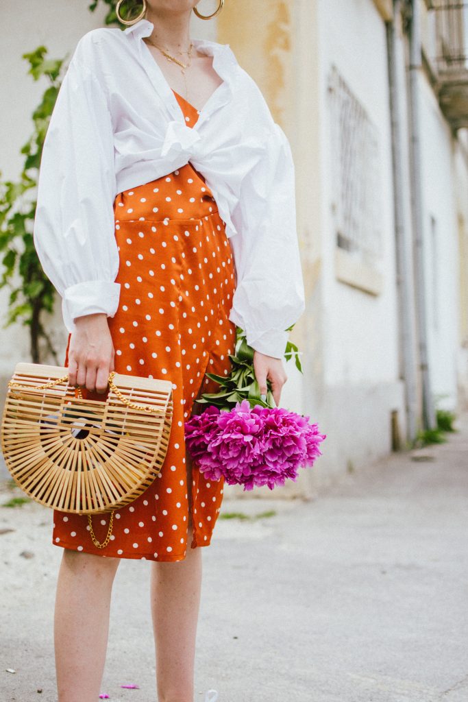 Orange boohoo midi polka dot midi dress, mango white balloon sleeve shirt shirt, h&m natural straw hat, cult gaia ark bag, tommy hilfiger white sneakers, andreea birsan, couturezilla, cute summer outfit ideas 2018. white trainers and dress, midi dress and sneakers, what to wear with a polka dot dress, midi polka dot dress with slit, orange dress, how to wear orange, what to wear with orange, rust color dress, what colors to wear this summer, how to wear sneakers and dresses, mixing feminine with masculine elements, athleisure, sexy polka dot dress, boater hat, cult gaia ark inspired bag, petite sardine bag, portuguese bag, bamboo bag, how to wear a white shirt, button up shirt, cotton shirt, how to layer in summer, layered summer dress, summer layers, white sneakers, white trainers, tommy hilfiger, gold accessories, small cat eye sunglasses, 90s inspired sunglasses, micro sunglasses trend, mini sunglasses, cat eye sunnies, the sold out asos sunglasses, chic bags to wear in spring and summer, raffia bag, straw bag, handmade bag, peonies, how to look Parisian chic, European summer street style inspiration for women 2017, pinterest chic outfit ideas for woman, summer outfit ideas, summer ootd inspiration, outfit of the day, ootd, fashion icon, style inspiration, fashionista, fashion inspiration, style inspo, what to wear in summer, how to look French, chic on a budget, zara outfit, mango, topshop, asos, river island, forever 21, urban outfitters, how to mix high end pieces with luxury ones, zara and Gucci,outfit alternatives for summer, tomboy chic, minimal outfit, tumblr girls photos, pictures, happy girl, women, smart casual outfits, the best outfit ideas 2017, what to wear when you don’t feel inspired, summer in Europe, weekend attire, uniform, French women in summer, European outfit ideas 2017, minimal chic outfit, how to stand out, the best outfit ideas for summer, the sunglasses you have seen everywhere on Instagram, glasses, uk fashion blogger, united kingdom, uk fashion blog, fashion and travel blog, Europe, women with style, street style, summer fashion trends 2017, best fashion ideas, styling, fall fashion, fall outfit, fall ootd, fall perfect, transitional dressing, best transitional outfit ideas, how to wear statement earrings, dressing for autumn, autumn outfit, winter outfit ideas for work and school 2017