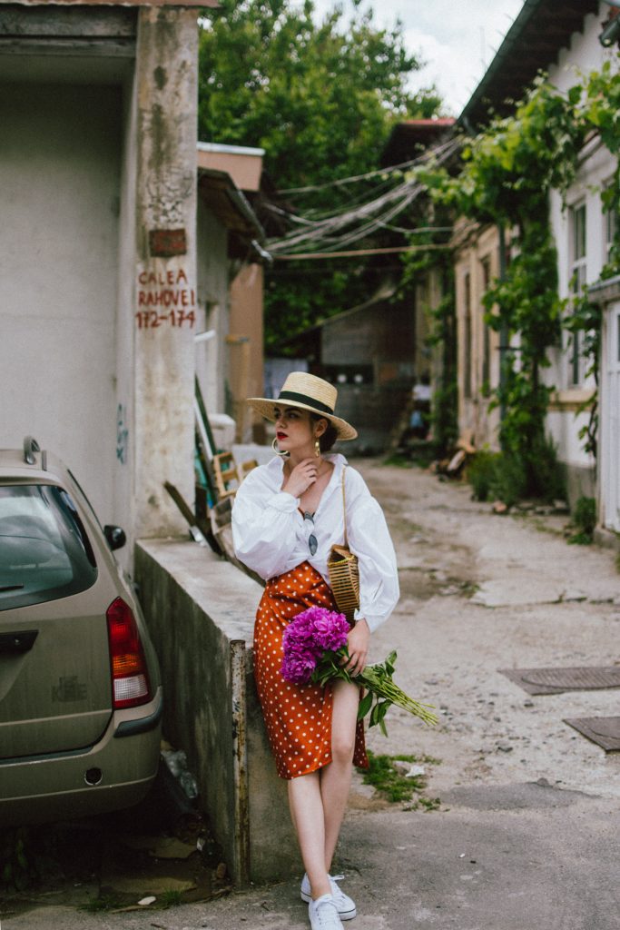 Orange boohoo midi polka dot midi dress, mango white balloon sleeve shirt shirt, h&m natural straw hat, cult gaia ark bag, tommy hilfiger white sneakers, andreea birsan, couturezilla, cute summer outfit ideas 2018. white trainers and dress, midi dress and sneakers, what to wear with a polka dot dress, midi polka dot dress with slit, orange dress, how to wear orange, what to wear with orange, rust color dress, what colors to wear this summer, how to wear sneakers and dresses, mixing feminine with masculine elements, athleisure, sexy polka dot dress, boater hat, cult gaia ark inspired bag, petite sardine bag, portuguese bag, bamboo bag, how to wear a white shirt, button up shirt, cotton shirt, how to layer in summer, layered summer dress, summer layers, white sneakers, white trainers, tommy hilfiger, gold accessories, small cat eye sunglasses, 90s inspired sunglasses, micro sunglasses trend, mini sunglasses, cat eye sunnies, the sold out asos sunglasses, chic bags to wear in spring and summer, raffia bag, straw bag, handmade bag, peonies, how to look Parisian chic, European summer street style inspiration for women 2017, pinterest chic outfit ideas for woman, summer outfit ideas, summer ootd inspiration, outfit of the day, ootd, fashion icon, style inspiration, fashionista, fashion inspiration, style inspo, what to wear in summer, how to look French, chic on a budget, zara outfit, mango, topshop, asos, river island, forever 21, urban outfitters, how to mix high end pieces with luxury ones, zara and Gucci,outfit alternatives for summer, tomboy chic, minimal outfit, tumblr girls photos, pictures, happy girl, women, smart casual outfits, the best outfit ideas 2017, what to wear when you don’t feel inspired, summer in Europe, weekend attire, uniform, French women in summer, European outfit ideas 2017, minimal chic outfit, how to stand out, the best outfit ideas for summer, the sunglasses you have seen everywhere on Instagram, glasses, uk fashion blogger, united kingdom, uk fashion blog, fashion and travel blog, Europe, women with style, street style, summer fashion trends 2017, best fashion ideas, styling, fall fashion, fall outfit, fall ootd, fall perfect, transitional dressing, best transitional outfit ideas, how to wear statement earrings, dressing for autumn, autumn outfit, winter outfit ideas for work and school 2017