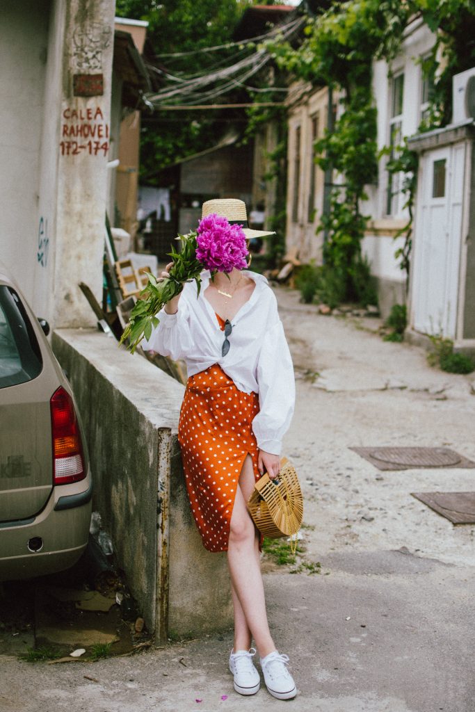 Orange boohoo midi polka dot midi dress, mango white balloon sleeve shirt shirt, h&m natural straw hat, cult gaia ark bag, tommy hilfiger white sneakers, andreea birsan, couturezilla, cute summer outfit ideas 2018. white trainers and dress, midi dress and sneakers, what to wear with a polka dot dress, midi polka dot dress with slit, orange dress, how to wear orange, what to wear with orange, rust color dress, what colors to wear this summer, how to wear sneakers and dresses, mixing feminine with masculine elements, athleisure, sexy polka dot dress, boater hat, cult gaia ark inspired bag, petite sardine bag, portuguese bag, bamboo bag, how to wear a white shirt, button up shirt, cotton shirt, how to layer in summer, layered summer dress, summer layers, white sneakers, white trainers, tommy hilfiger, gold accessories, small cat eye sunglasses, 90s inspired sunglasses, micro sunglasses trend, mini sunglasses, cat eye sunnies, the sold out asos sunglasses, chic bags to wear in spring and summer, raffia bag, straw bag, handmade bag, peonies, how to look Parisian chic, European summer street style inspiration for women 2017, pinterest chic outfit ideas for woman, summer outfit ideas, summer ootd inspiration, outfit of the day, ootd, fashion icon, style inspiration, fashionista, fashion inspiration, style inspo, what to wear in summer, how to look French, chic on a budget, zara outfit, mango, topshop, asos, river island, forever 21, urban outfitters, how to mix high end pieces with luxury ones, zara and Gucci,outfit alternatives for summer, tomboy chic, minimal outfit, tumblr girls photos, pictures, happy girl, women, smart casual outfits, the best outfit ideas 2017, what to wear when you don’t feel inspired, summer in Europe, weekend attire, uniform, French women in summer, European outfit ideas 2017, minimal chic outfit, how to stand out, the best outfit ideas for summer, the sunglasses you have seen everywhere on Instagram, glasses, uk fashion blogger, united kingdom, uk fashion blog, fashion and travel blog, Europe, women with style, street style, summer fashion trends 2017, best fashion ideas, styling, fall fashion, fall outfit, fall ootd, fall perfect, transitional dressing, best transitional outfit ideas, how to wear statement earrings, dressing for autumn, autumn outfit, winter outfit ideas for work and school 2017