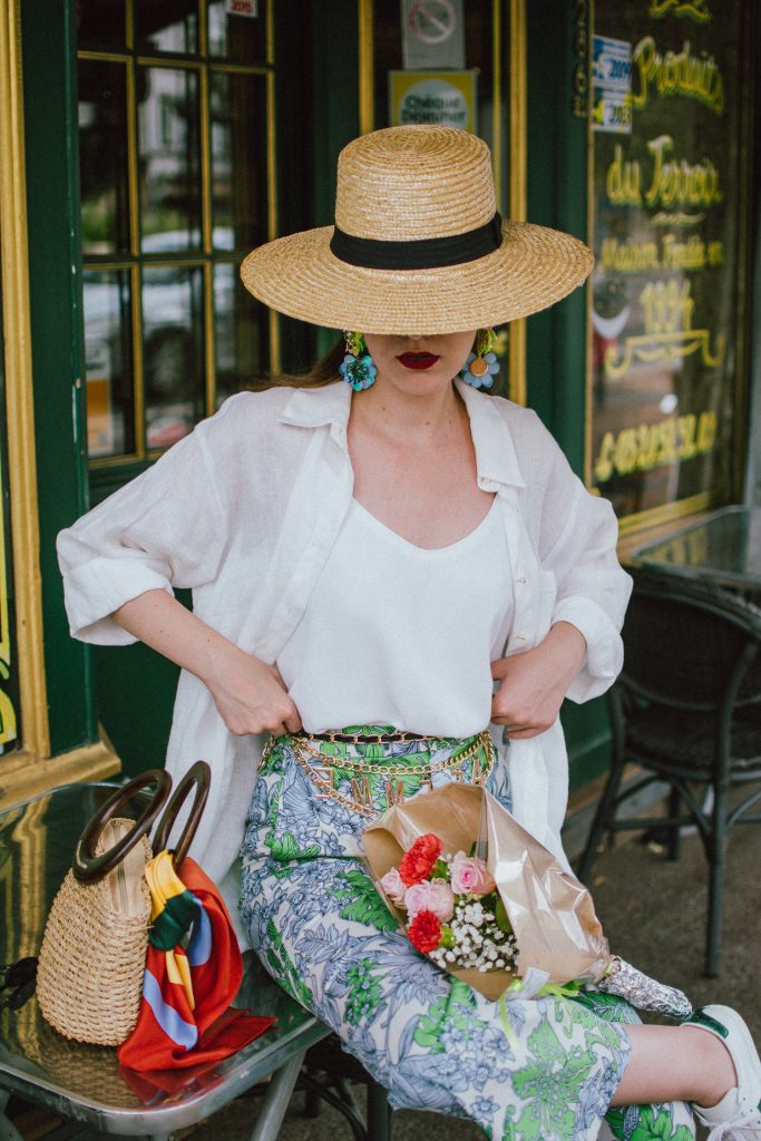 Zara floral print pants, flower print culottes, why you should wear floral print trousers, floral culottes, green blue and white pants, white cami top, mango camisole top, zara button down white linen shirt, boyfriend shirt, oversized shirt, gucci ace heart embroidered sneakers, gucci white sneakers, white leather sneakers, gucci trainers, h&m straw boater hat, summer straw bag with wooden handle, mini bag, the best summer bags, micro cat eye sunglasses, andreea birsan, couturezilla, cute summer outfit ideas 2018, sunnies, retro sunglasses, the asos sold out micro sunglasses, statement floral earrings, zara flower earrings, striped silk scarf, parisian cafe, andreea birsan travels to france, lille france, travel diary, what to wear when you travel to europe in summer, the perfect european summer outfit, how to wear a white shirt in different ways, handmade bags, bag made in thailand, wicker bag, natural fabric bag, how to wear florals, what to wear with floral printed pants, how to pull off culottes, what shoes to wear with culottes, tourist outfit, how to look Parisian chic, European summer street style inspiration for women 2017, pinterest chic outfit ideas for woman, summer outfit ideas, summer ootd inspiration, outfit of the day, ootd, fashion icon, style inspiration, fashionista, fashion inspiration, style inspo, what to wear in summer, how to look French, chic on a budget, zara outfit, mango, topshop, asos, river island, forever 21, urban outfitters, how to mix high end pieces with luxury ones, zara and Gucci,outfit alternatives for summer, tomboy chic, minimal outfit, tumblr girls photos, pictures, happy girl, women, smart casual outfits, the best outfit ideas 2017, what to wear when you don’t feel inspired, summer in Europe, weekend attire, uniform, French women in summer, European outfit ideas 2017, minimal chic outfit, how to stand out, the best outfit ideas for summer, the sunglasses you have seen everywhere on Instagram, glasses, uk fashion blogger, united kingdom, uk fashion blog, fashion and travel blog, Europe, women with style, street style, summer fashion trends 2017, best fashion ideas, styling, fall fashion, fall outfit, fall ootd, fall perfect, transitional dressing, best transitional outfit ideas, how to wear statement earrings, dressing for autumn, autumn outfit, winter outfit ideas for work and school 2017