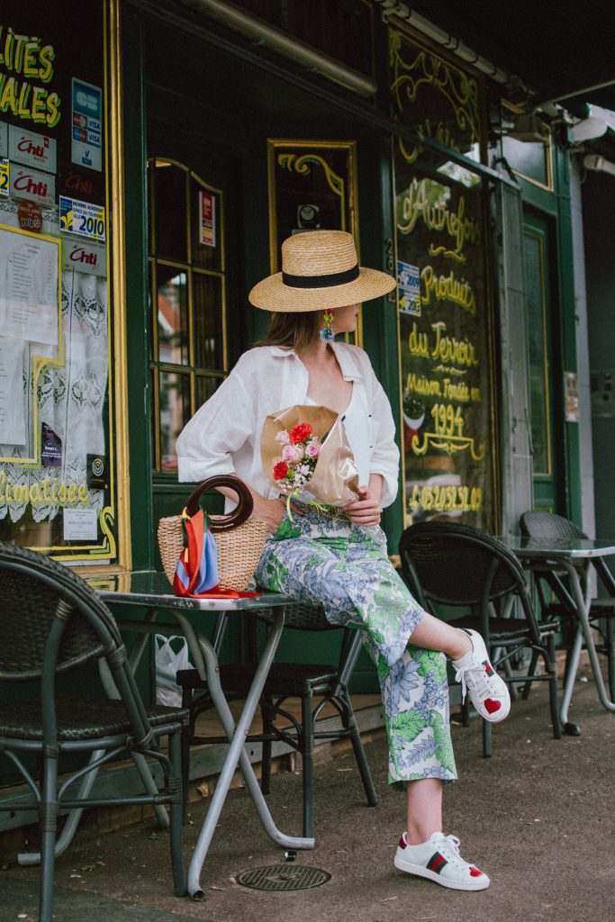 Zara floral print pants, flower print culottes, why you should wear floral print trousers, floral culottes, green blue and white pants, white cami top, mango camisole top, zara button down white linen shirt, boyfriend shirt, oversized shirt, gucci ace heart embroidered sneakers, gucci white sneakers, white leather sneakers, gucci trainers, h&m straw boater hat, summer straw bag with wooden handle, mini bag, the best summer bags, micro cat eye sunglasses, andreea birsan, couturezilla, cute summer outfit ideas 2018, sunnies, retro sunglasses, the asos sold out micro sunglasses, statement floral earrings, zara flower earrings, striped silk scarf, parisian cafe, andreea birsan travels to france, lille france, travel diary, what to wear when you travel to europe in summer, the perfect european summer outfit, how to wear a white shirt in different ways, handmade bags, bag made in thailand, wicker bag, natural fabric bag, how to wear florals, what to wear with floral printed pants, how to pull off culottes, what shoes to wear with culottes, tourist outfit, how to look Parisian chic, European summer street style inspiration for women 2017, pinterest chic outfit ideas for woman, summer outfit ideas, summer ootd inspiration, outfit of the day, ootd, fashion icon, style inspiration, fashionista, fashion inspiration, style inspo, what to wear in summer, how to look French, chic on a budget, zara outfit, mango, topshop, asos, river island, forever 21, urban outfitters, how to mix high end pieces with luxury ones, zara and Gucci,outfit alternatives for summer, tomboy chic, minimal outfit, tumblr girls photos, pictures, happy girl, women, smart casual outfits, the best outfit ideas 2017, what to wear when you don’t feel inspired, summer in Europe, weekend attire, uniform, French women in summer, European outfit ideas 2017, minimal chic outfit, how to stand out, the best outfit ideas for summer, the sunglasses you have seen everywhere on Instagram, glasses, uk fashion blogger, united kingdom, uk fashion blog, fashion and travel blog, Europe, women with style, street style, summer fashion trends 2017, best fashion ideas, styling, fall fashion, fall outfit, fall ootd, fall perfect, transitional dressing, best transitional outfit ideas, how to wear statement earrings, dressing for autumn, autumn outfit, winter outfit ideas for work and school 2017