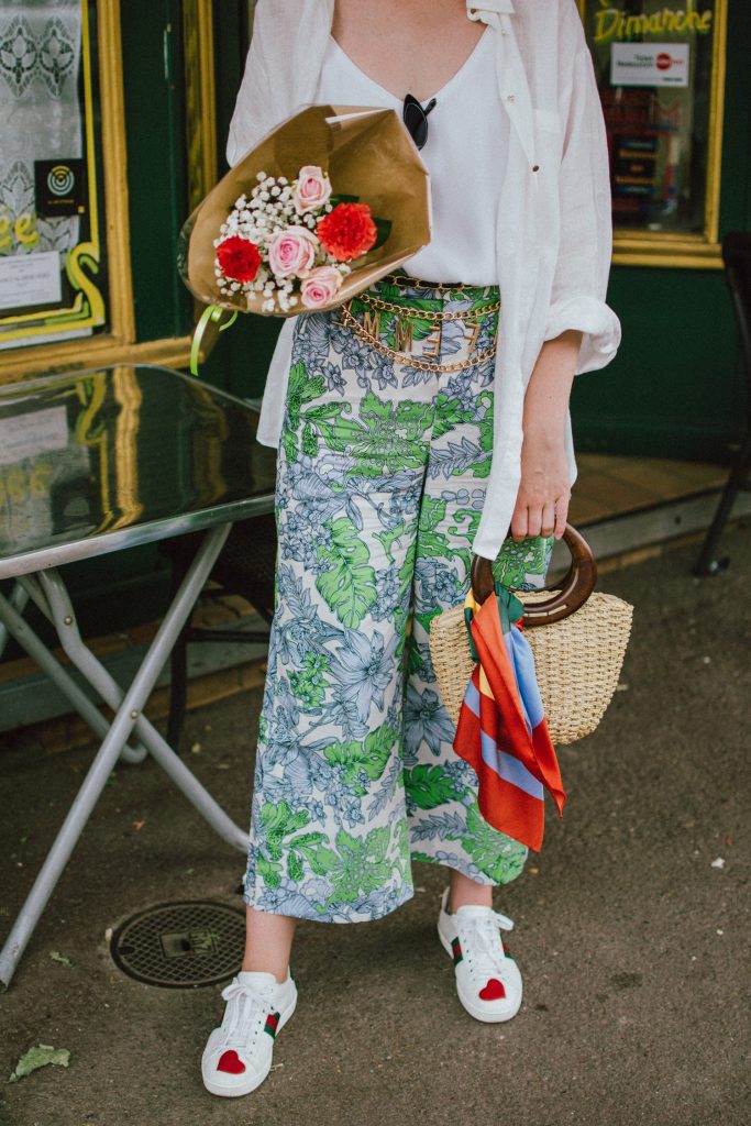 Zara floral print pants, flower print culottes, why you should wear floral print trousers, floral culottes, green blue and white pants, white cami top, mango camisole top, zara button down white linen shirt, boyfriend shirt, oversized shirt, gucci ace heart embroidered sneakers, gucci white sneakers, white leather sneakers, gucci trainers, h&m straw boater hat, summer straw bag with wooden handle, mini bag, the best summer bags, micro cat eye sunglasses, andreea birsan, couturezilla, cute summer outfit ideas 2018, sunnies, retro sunglasses, the asos sold out micro sunglasses, statement floral earrings, zara flower earrings, striped silk scarf, parisian cafe, andreea birsan travels to france, lille france, travel diary, what to wear when you travel to europe in summer, the perfect european summer outfit, how to wear a white shirt in different ways, handmade bags, bag made in thailand, wicker bag, natural fabric bag, how to wear florals, what to wear with floral printed pants, how to pull off culottes, what shoes to wear with culottes, tourist outfit, how to look Parisian chic, European summer street style inspiration for women 2017, pinterest chic outfit ideas for woman, summer outfit ideas, summer ootd inspiration, outfit of the day, ootd, fashion icon, style inspiration, fashionista, fashion inspiration, style inspo, what to wear in summer, how to look French, chic on a budget, zara outfit, mango, topshop, asos, river island, forever 21, urban outfitters, how to mix high end pieces with luxury ones, zara and Gucci,outfit alternatives for summer, tomboy chic, minimal outfit, tumblr girls photos, pictures, happy girl, women, smart casual outfits, the best outfit ideas 2017, what to wear when you don’t feel inspired, summer in Europe, weekend attire, uniform, French women in summer, European outfit ideas 2017, minimal chic outfit, how to stand out, the best outfit ideas for summer, the sunglasses you have seen everywhere on Instagram, glasses, uk fashion blogger, united kingdom, uk fashion blog, fashion and travel blog, Europe, women with style, street style, summer fashion trends 2017, best fashion ideas, styling, fall fashion, fall outfit, fall ootd, fall perfect, transitional dressing, best transitional outfit ideas, how to wear statement earrings, dressing for autumn, autumn outfit, winter outfit ideas for work and school 2017