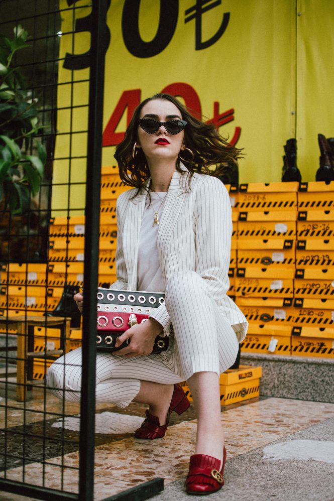 Mango stripe suit, red gucci shoes, A necklace, cat eye sunglasses, cavalli shoulder bag, andreea birsan in izmir turkey, couturezilla, cute fall outfit ideas 2018, womens pinstripe suit, power suit for women, striped suit, stripe trousers, stripe blazer, blazers with stripes, how to wear stripes, basic white t-shirt, boyfriend white tee, organic cotton white tee, embellished black cat eye sunglasses, just cavalli genuine leather shoulder bag with stripes and eyelets, statement bag, how to wear a statement bag, wedding guest outfit idea for those who don’t want to wear a dress, red gucci marmont pumps, red gucci heels, red leather shoes, dark white, celine inspired initial necklace, gold accessories, gold necklace, moschino inspired black pointy cat eye sunglasses, red white and black crossbody bag, yellow bag strap, how to rock a suit in fall 2018, how to look Parisian chic, European summer street style inspiration for women 2017, pinterest chic outfit ideas for woman, summer outfit ideas, summer ootd inspiration, outfit of the day, ootd, fashion icon, style inspiration, fashionista, fashion inspiration, style inspo, what to wear in summer, how to look French, chic on a budget, zara outfit, mango, topshop, asos, river island, forever 21, urban outfitters, how to mix high end pieces with luxury ones, zara and Gucci,outfit alternatives for summer, tomboy chic, minimal outfit, tumblr girls photos, pictures, happy girl, women, smart casual outfits, the best outfit ideas 2017, what to wear when you don’t feel inspired, summer in Europe, weekend attire, uniform, French women in summer, European outfit ideas 2017, minimal chic outfit, how to stand out, the best outfit ideas for summer, the sunglasses you have seen everywhere on Instagram, glasses, uk fashion blogger, united kingdom, uk fashion blog, fashion and travel blog, Europe, women with style, street style, summer fashion trends 2017, best fashion ideas, styling, fall fashion, fall outfit, fall ootd, fall perfect, transitional dressing, best transitional outfit ideas, how to wear statement earrings, dressing for autumn, autumn outfit, winter outfit ideas for work and school 2017