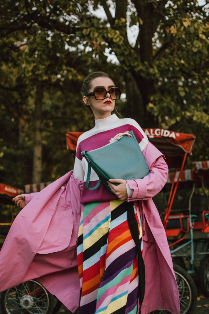 Zara pink trench coat, rainbow midi skirt, turtleneck sweater, mywalit bag, white shoes, andreea birsan, couturezilla, cute fall outfit ideas 2018, stripe midi skirt, topshop rainbow skirt, multi color skirt, how to wear a rainbow skirt, striped mango sweater, how to wear pink and purple, purple and white turtleneck sweater, cozy sweater, balloon sleeve sweater, chunky knit, white leather pumps, white leather high heel shoes, how to wear white shoes, striped skirt, how to wear double stripes, italian leather bag, pastel green bag, big gucci inspired sunglasses, tortoise sunglasses, autumn layers, pink mac, pink autumn coat, how to wear a pink coat, what colors to wear with pink, washed grey bag, teal bag, knot detail bag, mywalit teal hobo bag with knot detail, colorful fall outfit 2018, how to wear colors in autumn, how to look Parisian chic, European summer street style inspiration for women 2017, pinterest chic outfit ideas for woman, summer outfit ideas, summer ootd inspiration, outfit of the day, ootd, fashion icon, style inspiration, fashionista, fashion inspiration, style inspo, what to wear in summer, how to look French, chic on a budget, zara outfit, mango, topshop, asos, river island, forever 21, urban outfitters, how to mix high end pieces with luxury ones, zara and Gucci,outfit alternatives for summer, tomboy chic, minimal outfit, tumblr girls photos, pictures, happy girl, women, smart casual outfits, the best outfit ideas 2017, what to wear when you don’t feel inspired, summer in Europe, weekend attire, uniform, French women in summer, European outfit ideas 2017, minimal chic outfit, how to stand out, the best outfit ideas for summer, the sunglasses you have seen everywhere on Instagram, glasses, uk fashion blogger, united kingdom, uk fashion blog, fashion and travel blog, Europe, women with style, street style, summer fashion trends 2017, best fashion ideas, styling, fall fashion, fall outfit, fall ootd, fall perfect, transitional dressing, best transitional outfit ideas, how to wear statement earrings, dressing for autumn, autumn outfit, winter outfit ideas for work and school