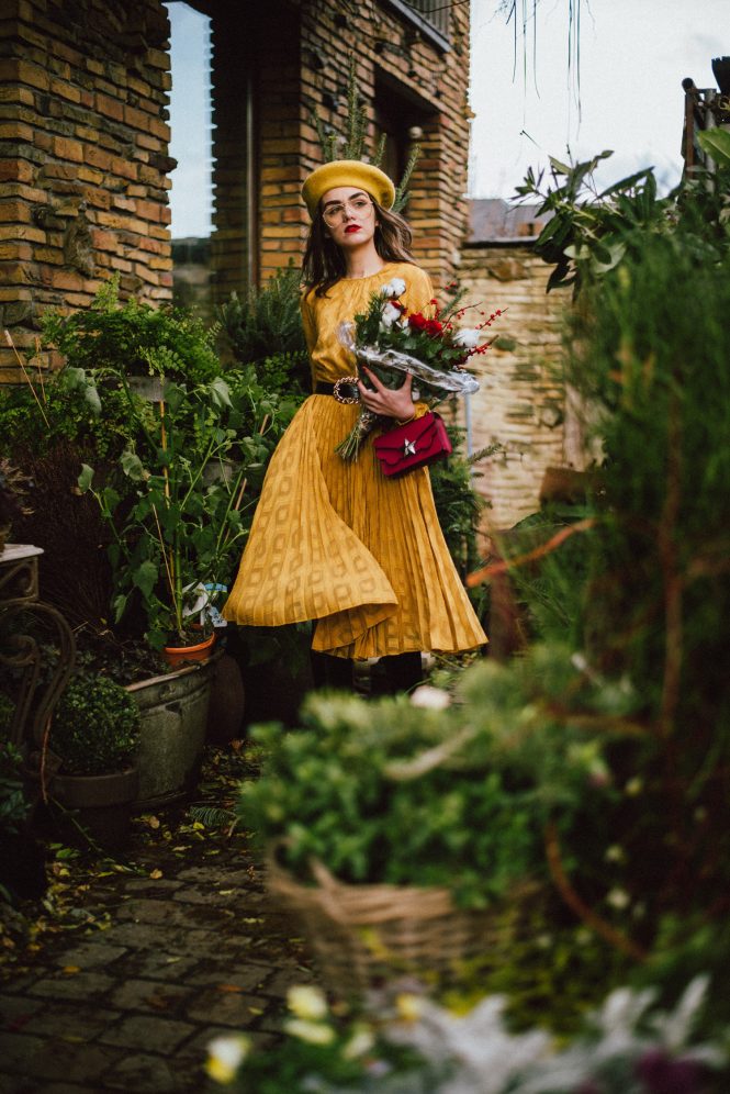 Yellow pleated midi dress, black knee length boots, red mini bag, yellow beret, cute winter outfit ideas 2019 andreea birsan, couturezilla street style, the yellow midi dress you will love, open back yellow dress, pleated midi dress, the best shade of yellow, what other color to wear yellow with, pink mini bag, les jeunes etoiles vega mini bag in pink red, the mini bag you need, genuine leather bags, how to wear colors in winter, yellow beret, how to style a beret, clear lens aviator glasses, knee high black boots, ottod’ame boots, italian leather black boots, how to wear knee length boots with dresses, fishnet stockings, schilde belgium, what to wear in winter, festive dresses, the only yellow dress you need, chic outfits for warmer winters, shopbop bag, 2018 fresh casual ideas, american style, andreea birsan street styles, asos, casual off duty style, couturezilla, cute and casual outfits for spring 2018, european fashion blogger, fashion inspiration, fashion inspo, fashionista, how to dress like a parisian, how to look parisian chic, how to make minimal outfits stand out, mango, minimal outfits for spring, modern minimalism, ootd, outfit of the day, pinterest outfit for women, red cat eye sunglasses, red lipstick, romanian fashion blog, romanian fashion blogger, silk scarf, spring fashion trends for 2019, spring outfit inspiration 2019, spring outfits for women, spring street style 2019, topshop, tumblr girls outfit, women with style, zara, uk blogger, fall dressing, transitional outfits, autumn ootd, autumn outfit, fall fashion, winter outfit ideas 2019, cute winter ootd, winter outfit ideas for work and school, street style 2019